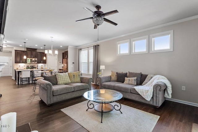 living area with crown molding, dark wood-style flooring, ceiling fan with notable chandelier, and recessed lighting