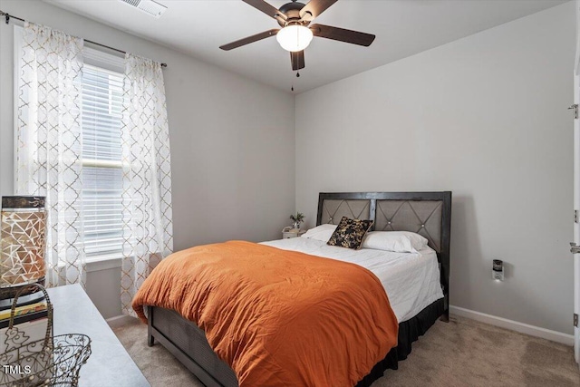 bedroom with carpet floors, baseboards, ceiling fan, and visible vents