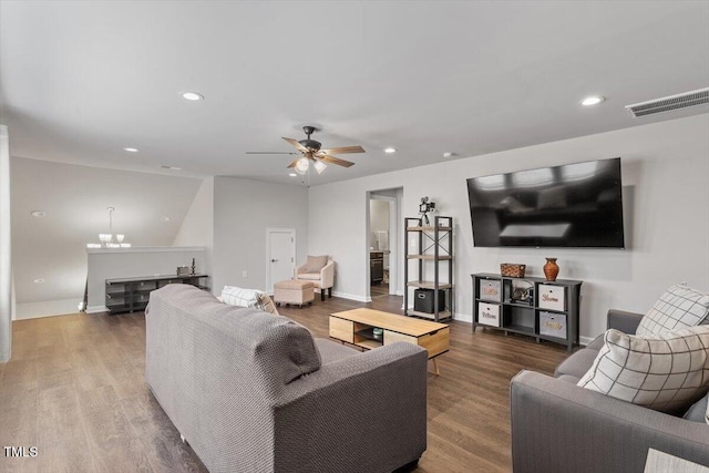 living area with recessed lighting, visible vents, wood finished floors, and ceiling fan with notable chandelier