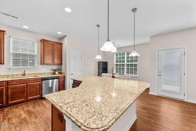 kitchen featuring a sink, visible vents, light wood-type flooring, and dishwasher