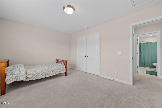 carpeted bedroom with baseboards and a closet