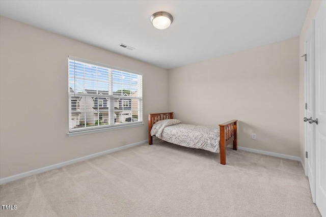 bedroom with light colored carpet, baseboards, and visible vents