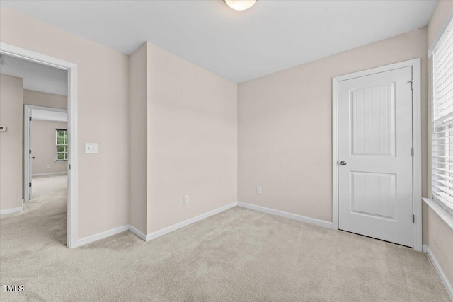 empty room with carpet flooring and baseboards