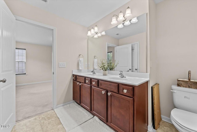 full bathroom featuring a sink, toilet, and double vanity