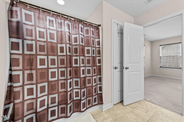 full bath featuring baseboards, tile patterned floors, and curtained shower