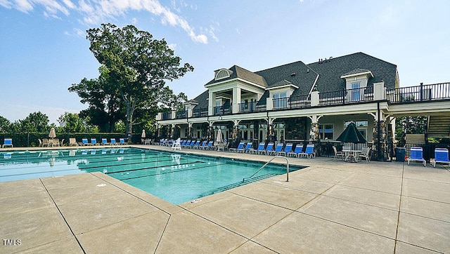 community pool featuring fence and a patio area