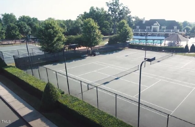 view of tennis court with fence