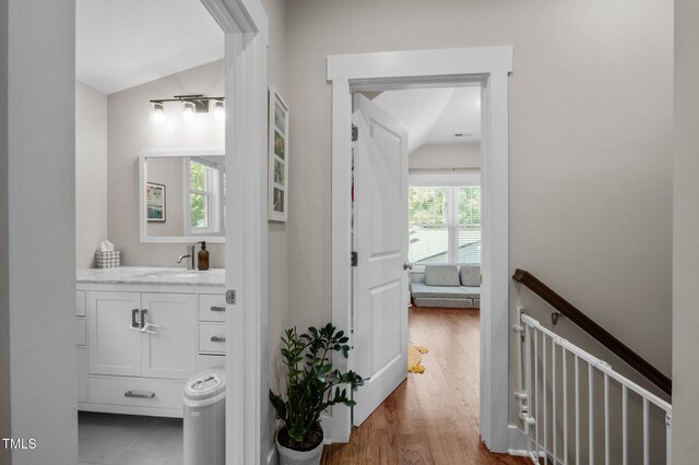 2003 Wa Wa Ave, Durham, NC 27707 - hall featuring a sink, wood finished floors, vaulted ceiling, and an upstairs landing