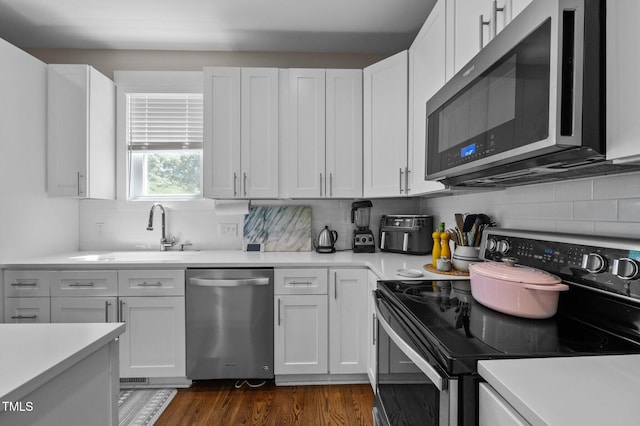 2003 Wa Wa Ave, Durham, NC 27707 - kitchen with a sink, appliances with stainless steel finishes, white cabinets, and light countertops