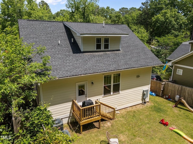 2003 Wa Wa Ave, Durham, NC 27707 - back of property featuring a yard, a deck, fence, and roof with shingles