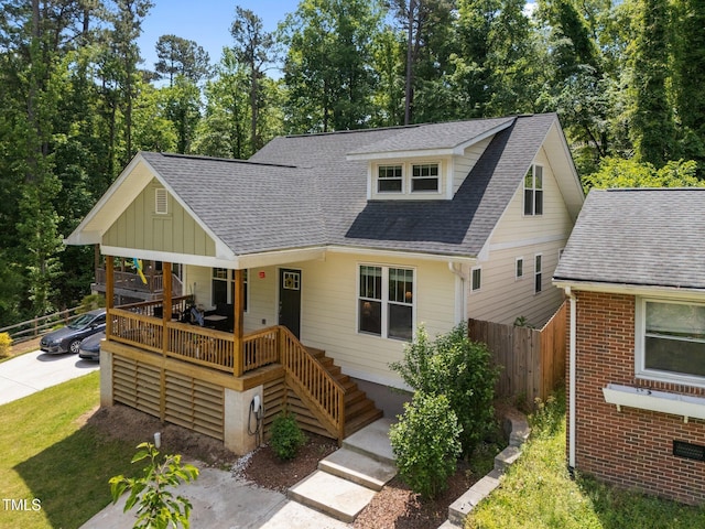2003 Wa Wa Ave, Durham, NC 27707 - view of front of home with board and batten siding, a porch, fence, and roof with shingles