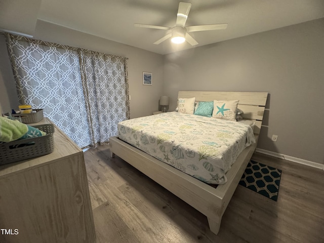 504 Carolina Beach Ave S Unit 2L, Carolina Beach, NC 28428 - bedroom with wood finished floors, baseboards, and a ceiling fan
