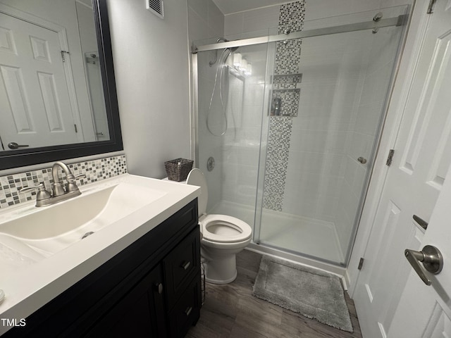 504 Carolina Beach Ave S Unit 2L, Carolina Beach, NC 28428 - full bath with vanity, wood finished floors, toilet, and a stall shower