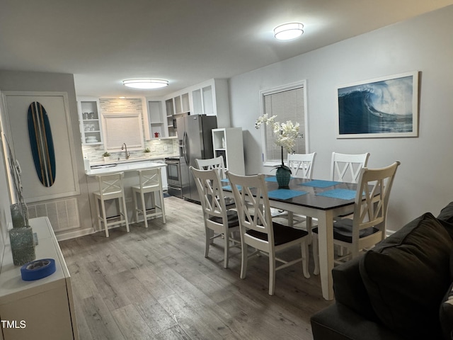 504 Carolina Beach Ave S Unit 2L, Carolina Beach, NC 28428 - dining room with light wood-style flooring
