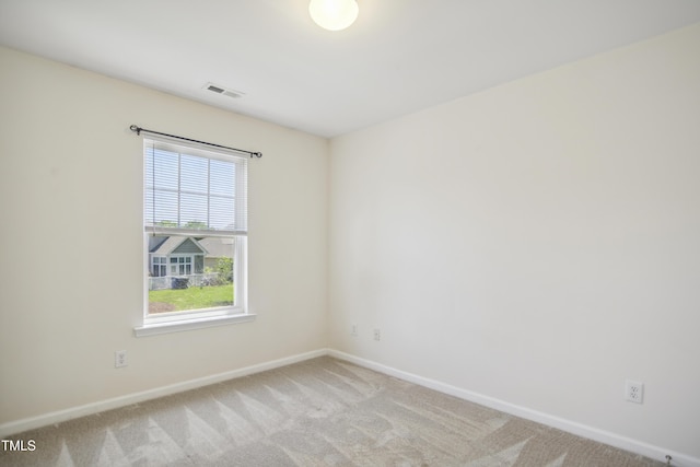 unfurnished room featuring visible vents, carpet flooring, and baseboards