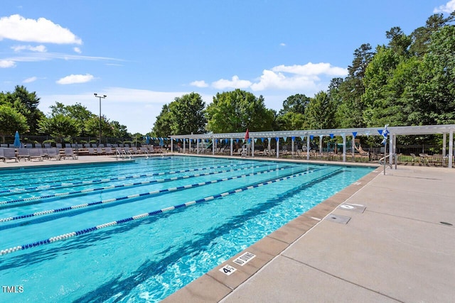 view of swimming pool featuring fence