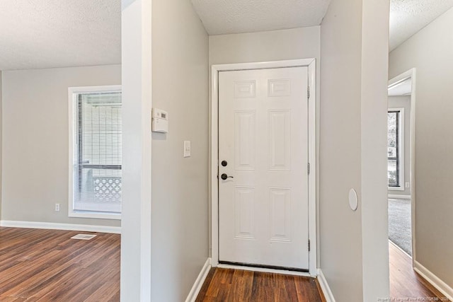 5516 Deep Hollow Ct, Fayetteville, NC 28311 - doorway to outside with baseboards, a textured ceiling, and dark wood-style flooring