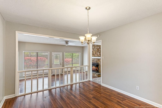 5516 Deep Hollow Ct, Fayetteville, NC 28311 - spare room featuring a fireplace, a chandelier, wood finished floors, and baseboards