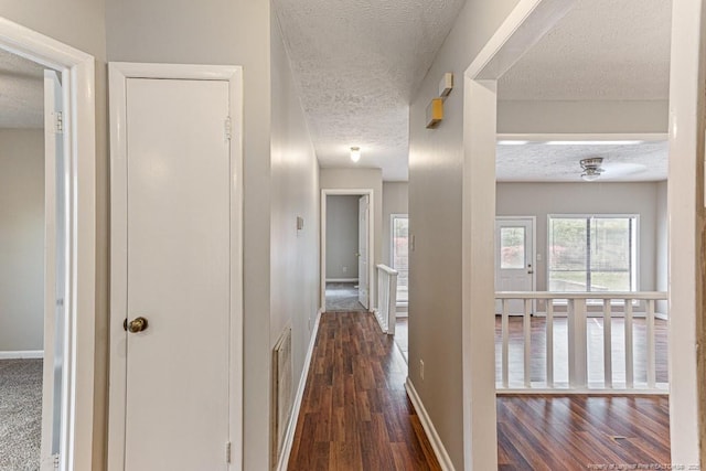 5516 Deep Hollow Ct, Fayetteville, NC 28311 - hallway with a textured ceiling, visible vents, hardwood / wood-style flooring, and baseboards