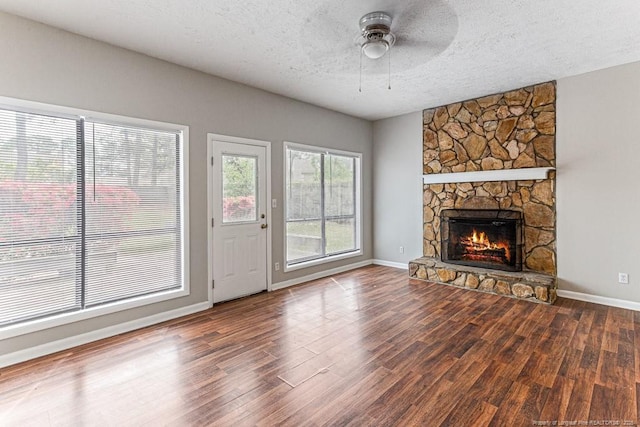 5516 Deep Hollow Ct, Fayetteville, NC 28311 - unfurnished living room featuring a fireplace, ceiling fan, baseboards, a textured ceiling, and wood finished floors
