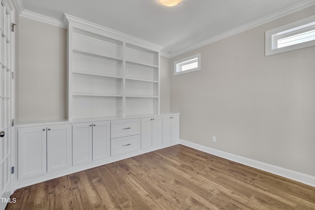 127 Post Oak Rd, Chapel Hill, NC 27516 - empty room featuring ornamental molding, baseboards, wood finished floors, and built in shelves