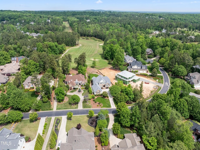 aerial view featuring a residential view, golf course view, and a forest view