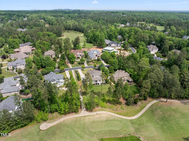 aerial view featuring a residential view, a view of trees, and view of golf course