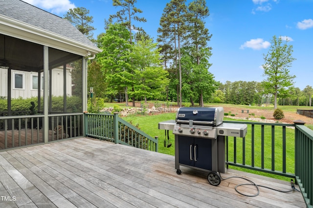 wooden deck with a lawn, a sunroom, and grilling area