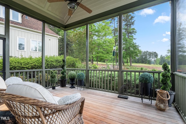 sunroom featuring a ceiling fan