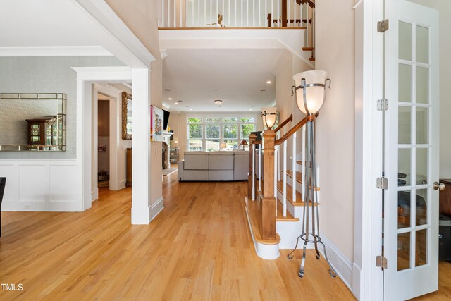 foyer with recessed lighting, ornamental molding, wood finished floors, and stairway