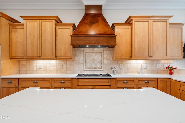 kitchen featuring custom range hood, cooktop, ornamental molding, and tasteful backsplash