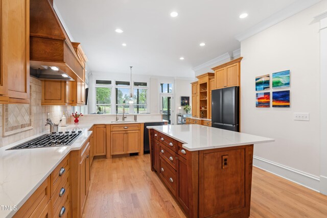 kitchen featuring crown molding, freestanding refrigerator, open shelves, light wood-type flooring, and stainless steel gas stovetop