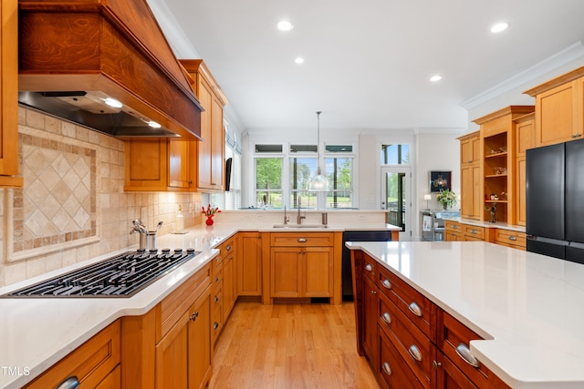 kitchen with light countertops, recessed lighting, gas cooktop, and a sink