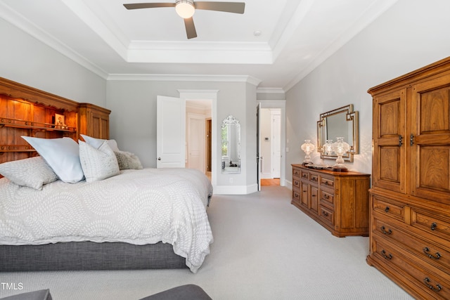 bedroom with ornamental molding, light carpet, baseboards, a raised ceiling, and a ceiling fan