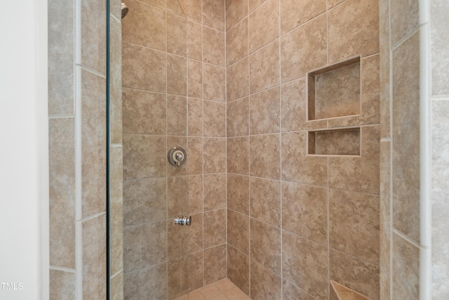 bathroom with tiled shower