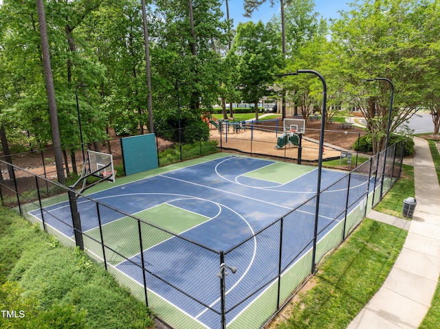 view of basketball court featuring fence and community basketball court