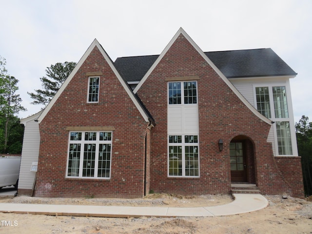 2590 Silas Peak Ln, Apex, NC 27523 - tudor house with brick siding and a shingled roof