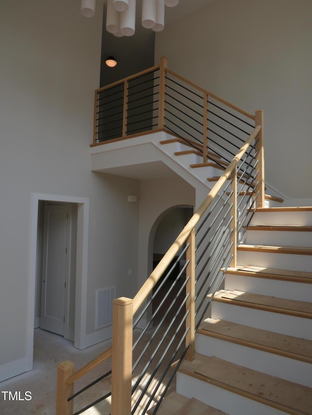 2590 Silas Peak Ln, Apex, NC 27523 - stairway featuring a high ceiling and arched walkways
