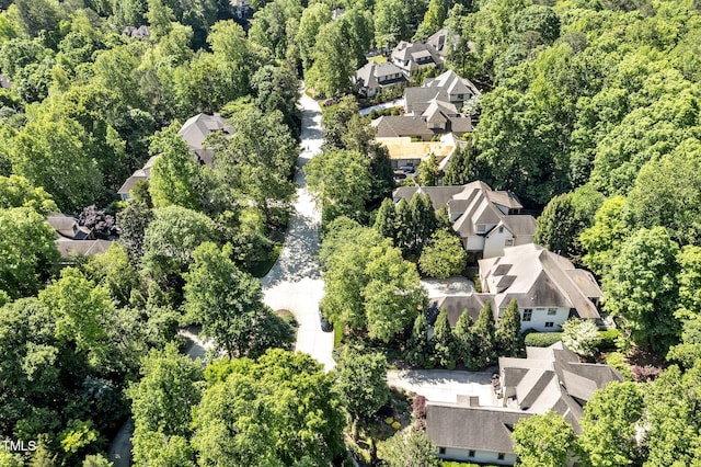 aerial view featuring a wooded view and a residential view