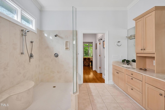 bathroom featuring vanity, tile patterned flooring, ornamental molding, and walk in shower