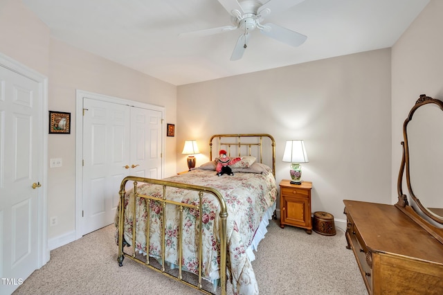 bedroom featuring baseboards, light carpet, and a closet
