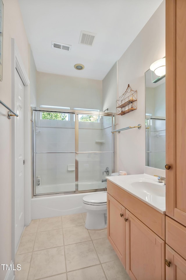 bathroom featuring shower / bath combination with glass door, tile patterned floors, visible vents, and vanity