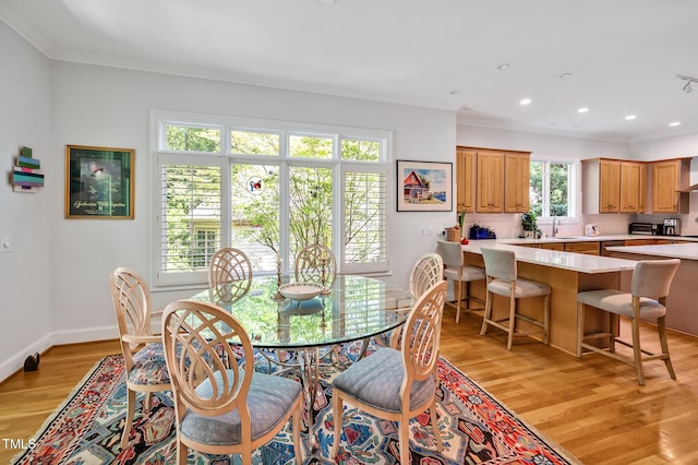 dining area featuring recessed lighting, baseboards, ornamental molding, and light wood-style flooring