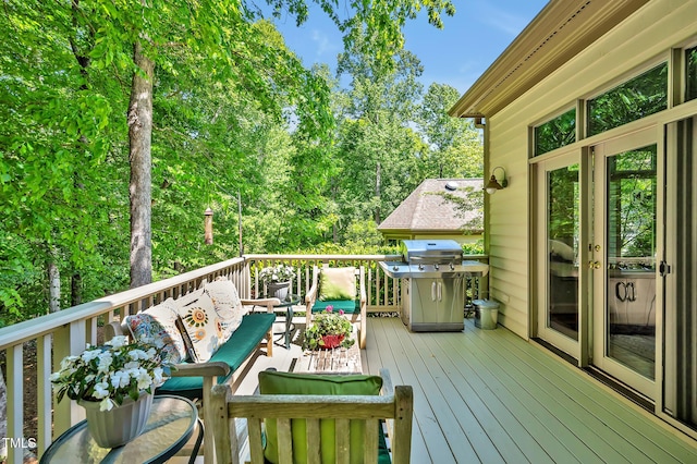 deck with outdoor lounge area and a grill