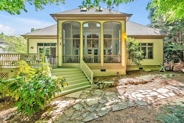 back of property with crawl space, a shingled roof, a sunroom, and a deck