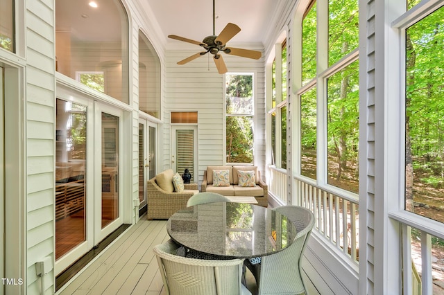 sunroom featuring a ceiling fan