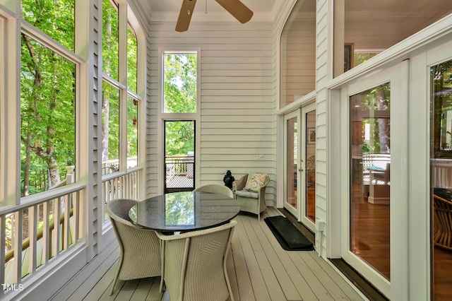 sunroom featuring a healthy amount of sunlight and ceiling fan