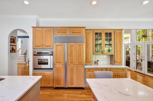 kitchen with crown molding, oven, recessed lighting, and paneled built in refrigerator