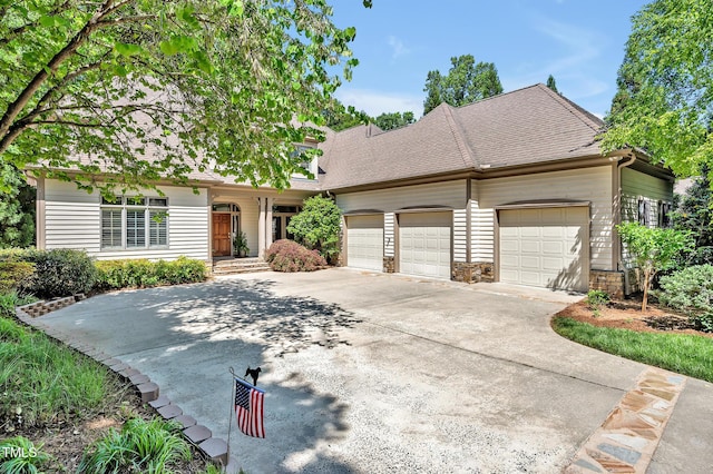 view of front of home with a garage, a shingled roof, driveway, and stone siding