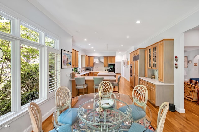 dining room with recessed lighting, baseboards, ornamental molding, and light wood-style floors